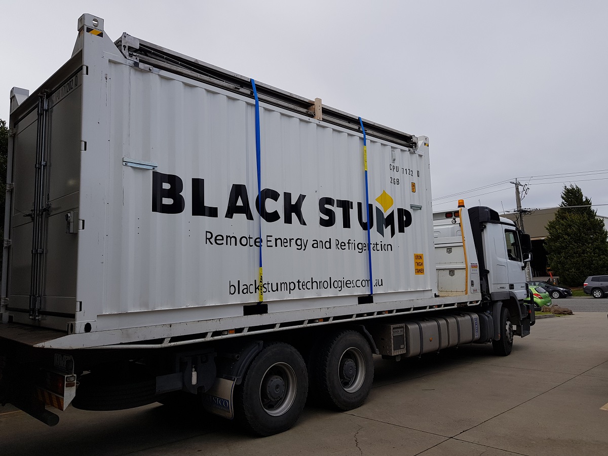 Custom Solarator® office being transported on a flatbed truck